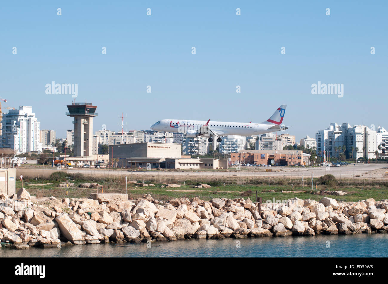 Arkia, Embraer ERJ-195 landing at the Sde Dov Airport (IATA: SDV, ICAO: LLSD) in Tel Aviv, Israel Stock Photo