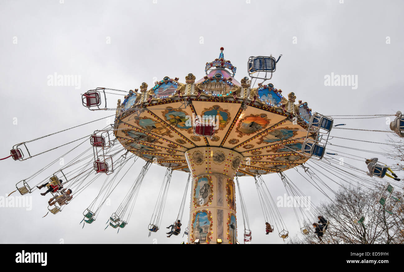 LONDON HYDE PARK WINTER WONDERLAND A SPINNING CAROUSEL  OR MERRY GO ROUND WITH PASSENGERS ON THE CHAIRS Stock Photo