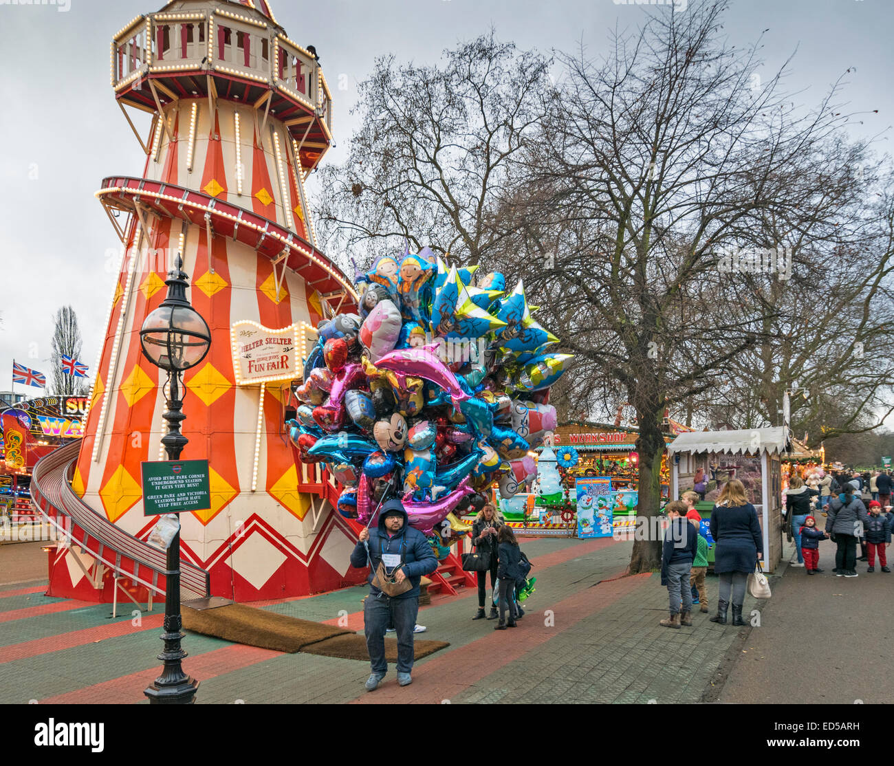 LONDON WINTER WONDERLAND IN HYDE PARK A MAN WITH MULTI - COLOURED  BALLOONS FOR SALE Stock Photo