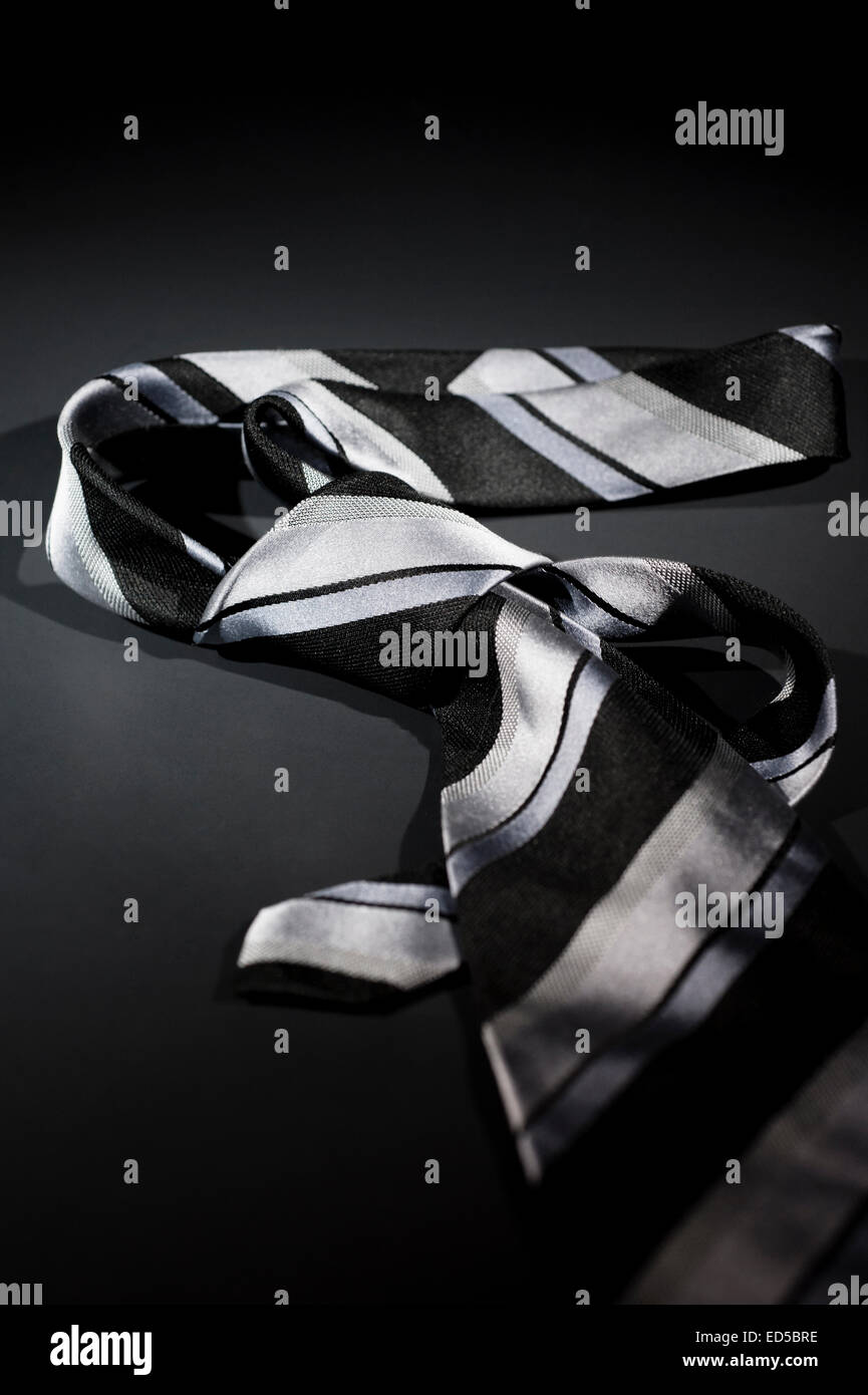 Gray necktie on a black background Stock Photo Alamy