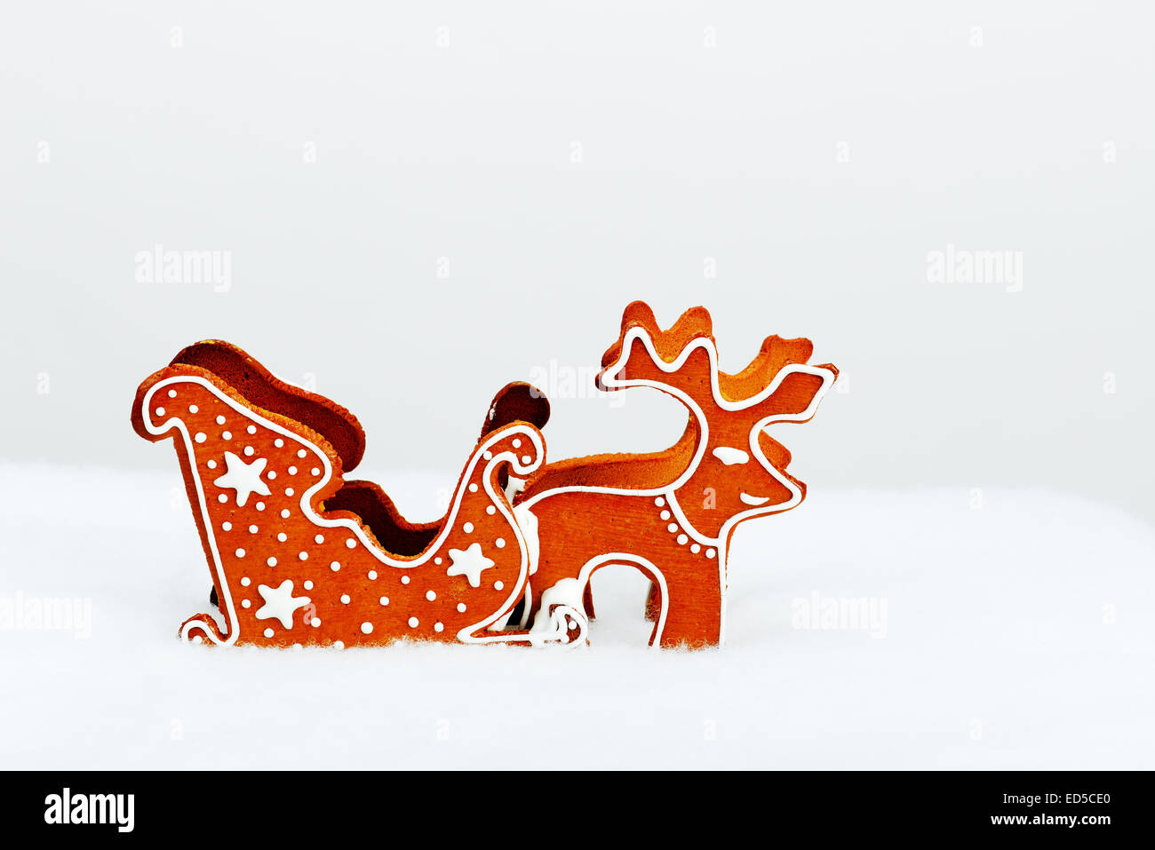 The hand-made eatable reindeer and cart with snow decoration Stock Photo