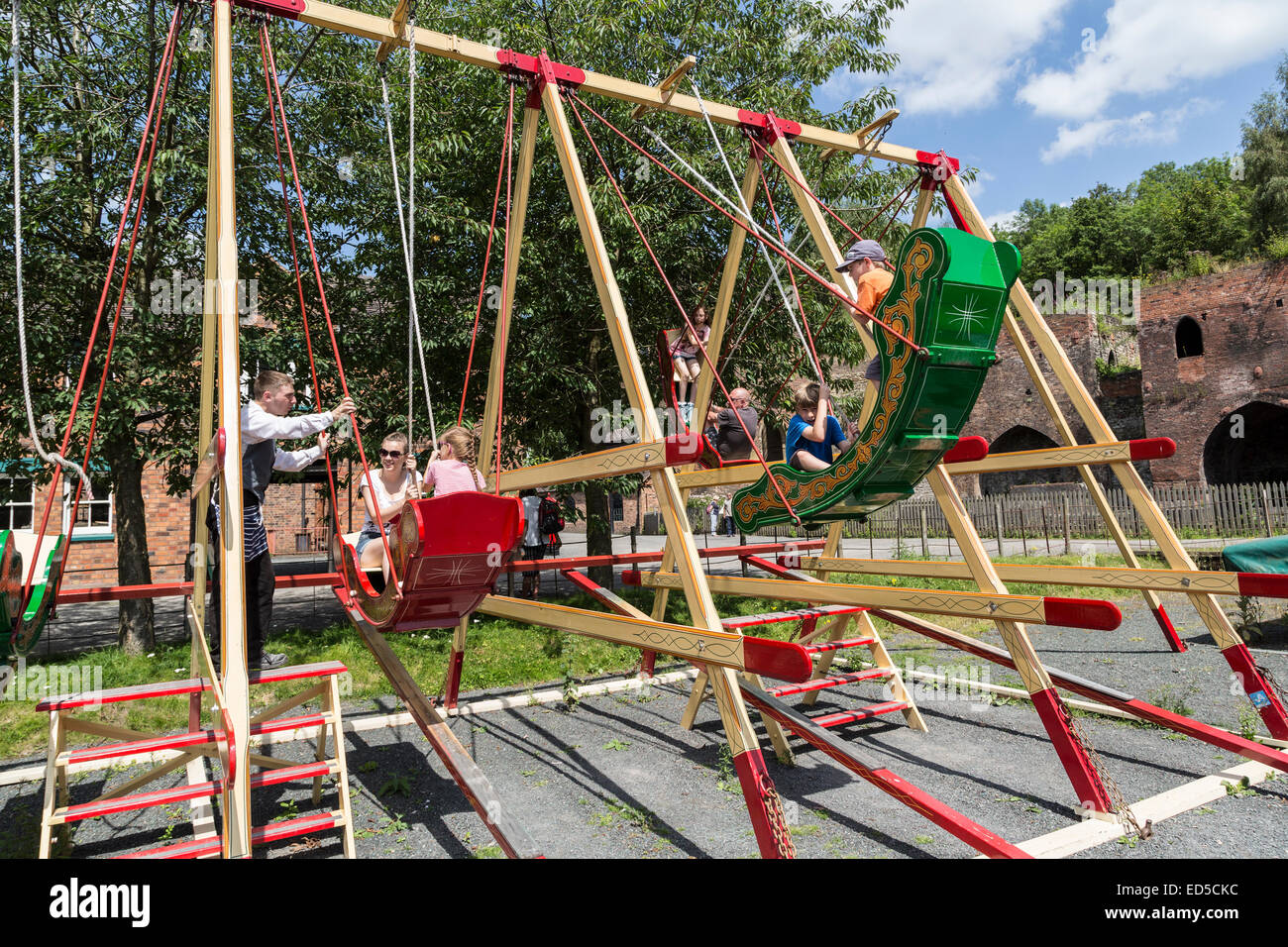 Children on fun fair swing ride, Blists Hill Victorian town, Ironbridge, Shropshire, England, UK Stock Photo