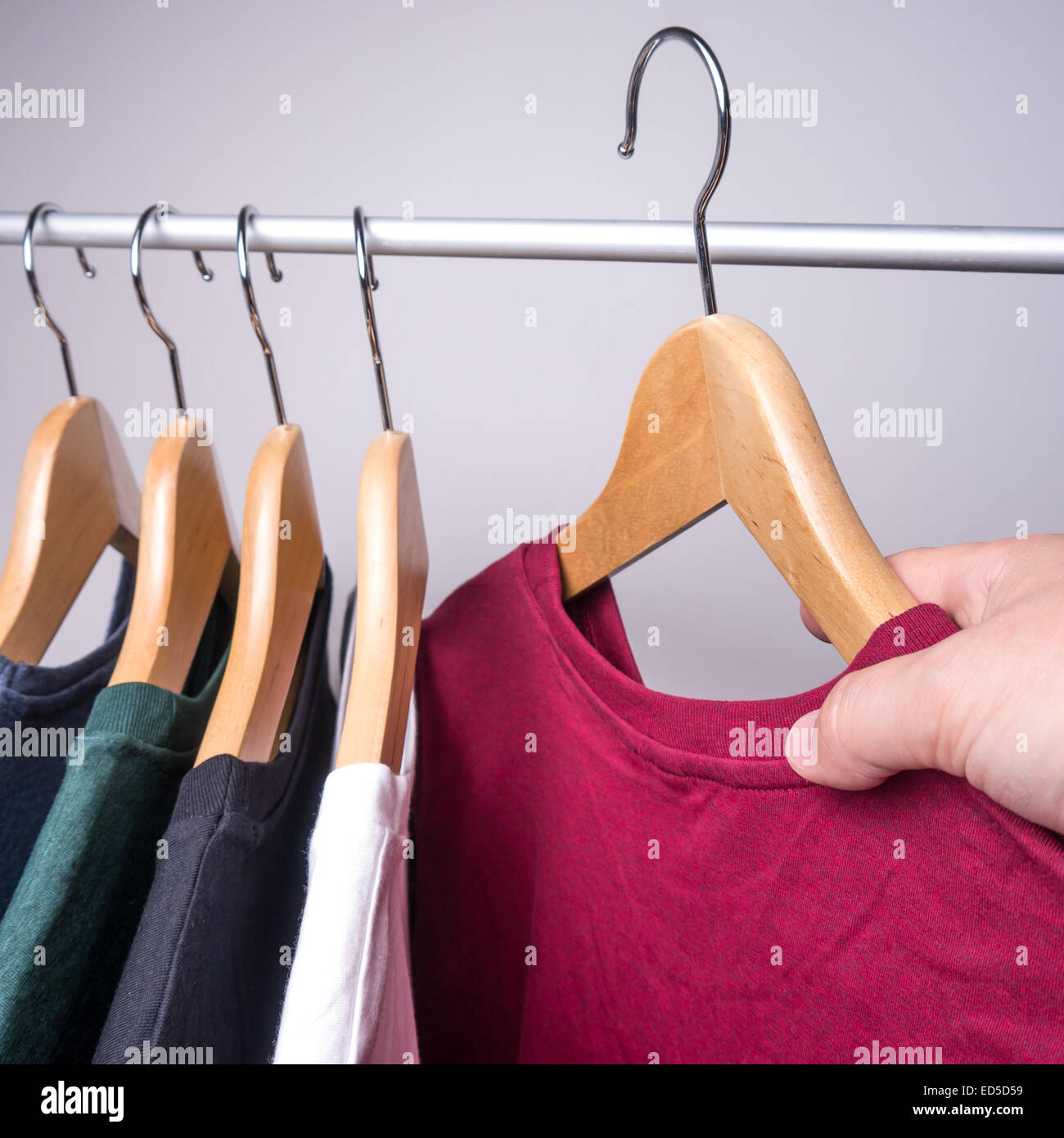 hangers with t-shirts in different colors Stock Photo