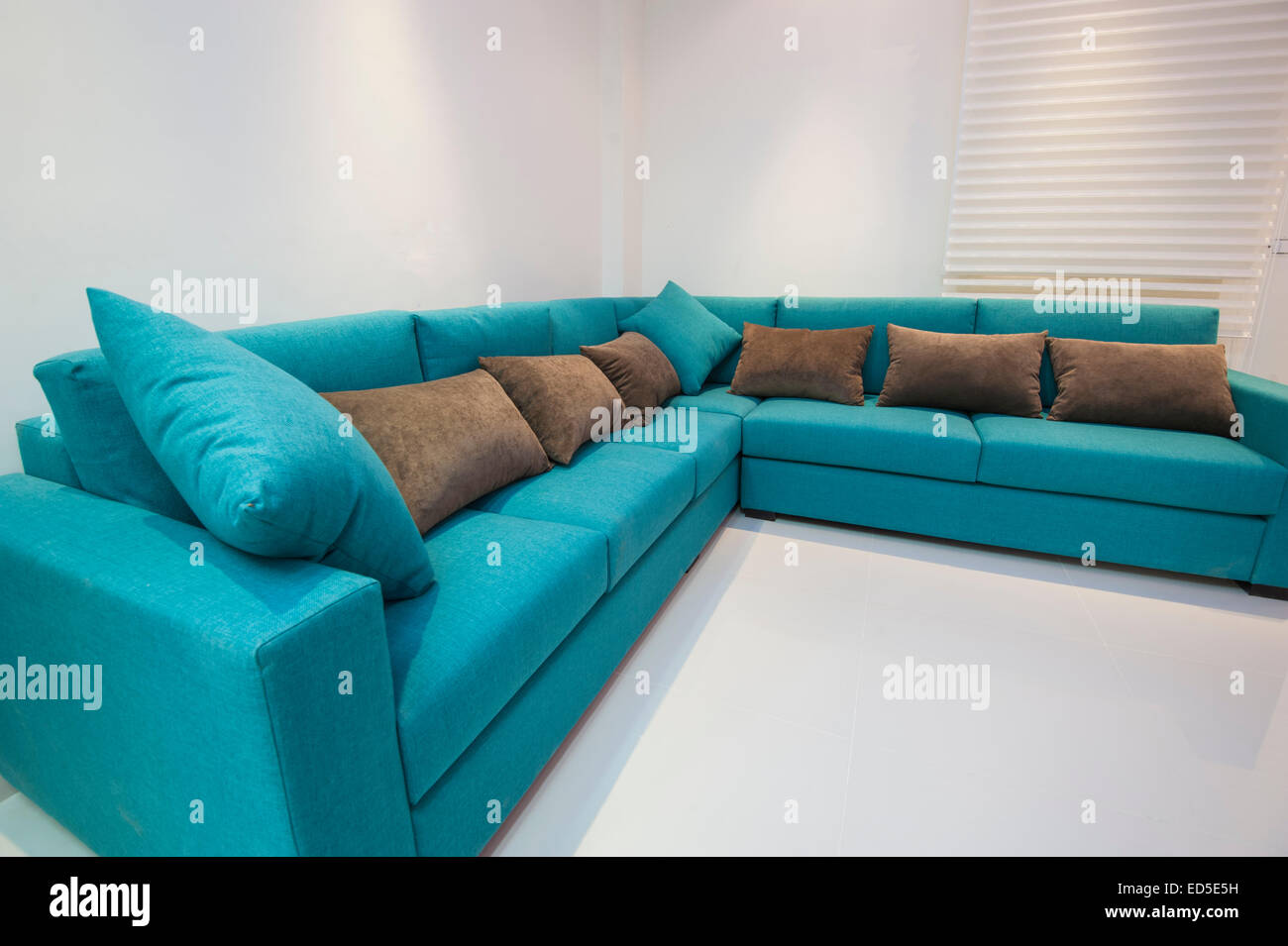 Corner sofa with cushions in luxury apartment living room Stock Photo