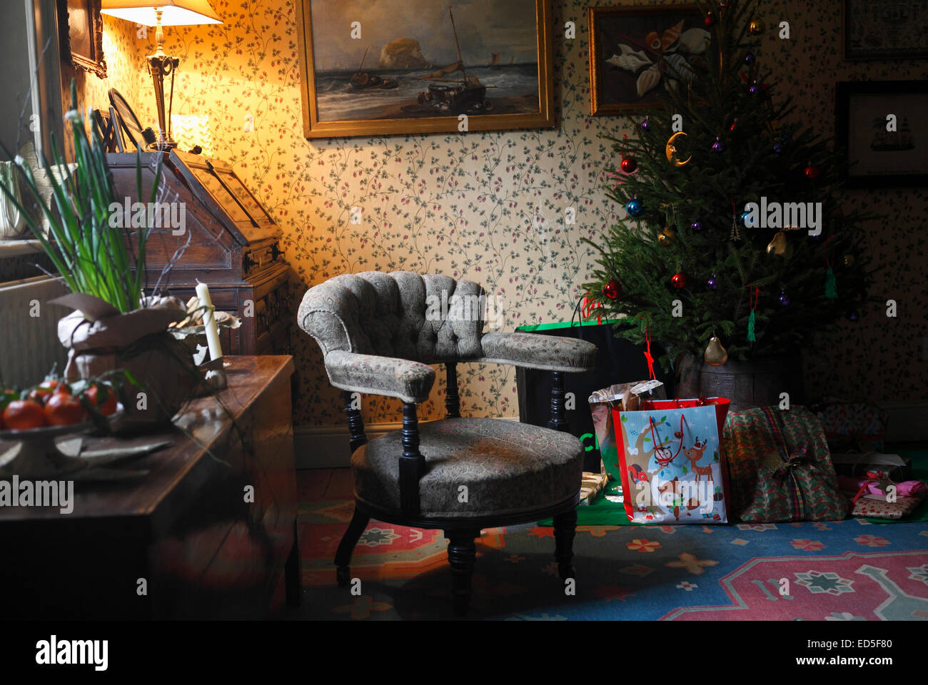 Drawing room interior at Chistmas time with a vacant chair. Stock Photo