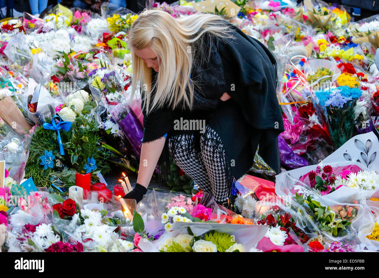 More than 1000 people took part in a 2 minute candle vigil in Royal Exchange Square, Glasgow in remembrance of the 6 people who were victims of the Glasgow Bin lorry crash in George Square a week ago. Many people brought  flowers, candles and some said prayers as a mark of support and condolences. Stock Photo