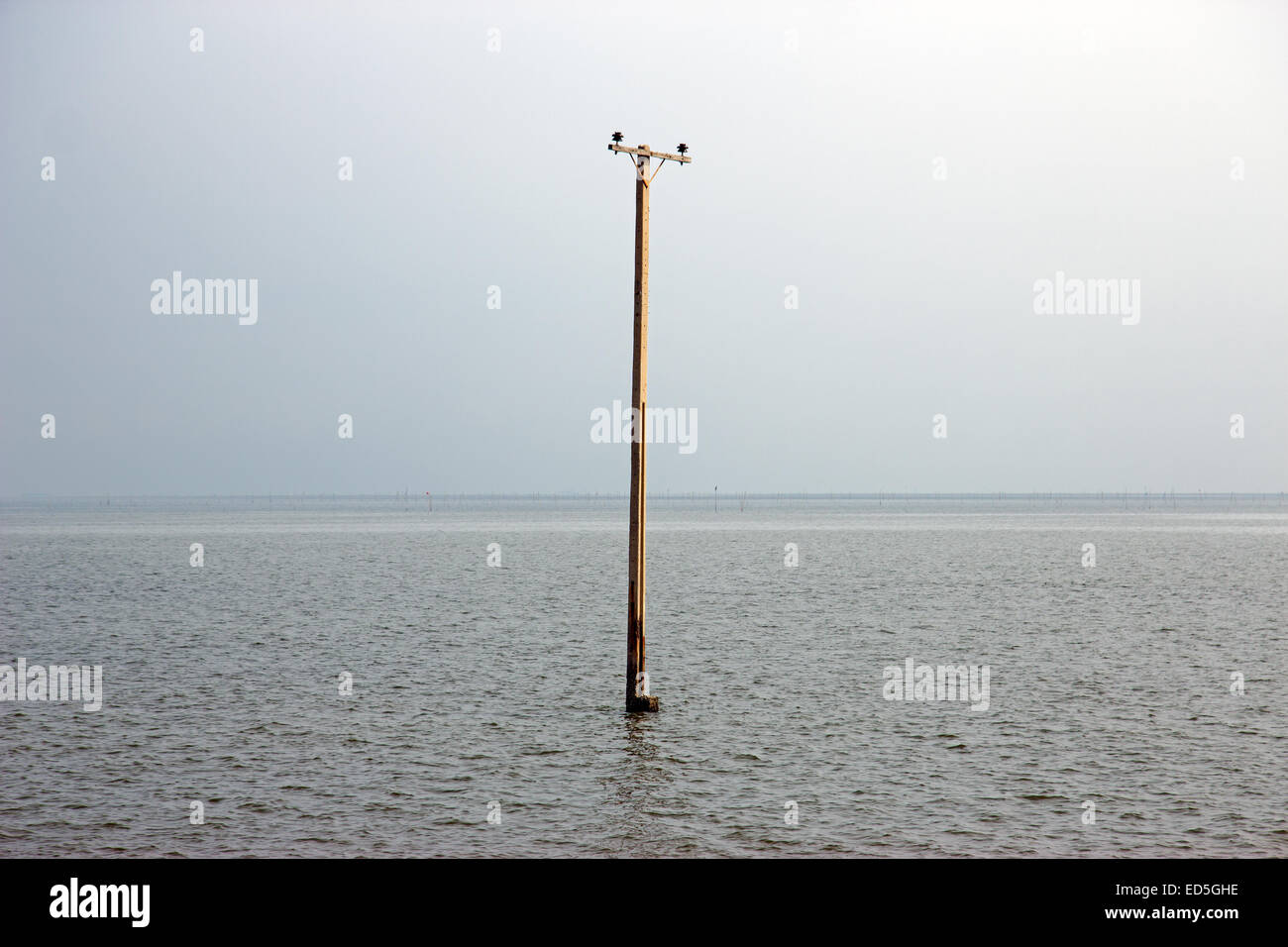 abandoned flooded pillar in the sea Stock Photo