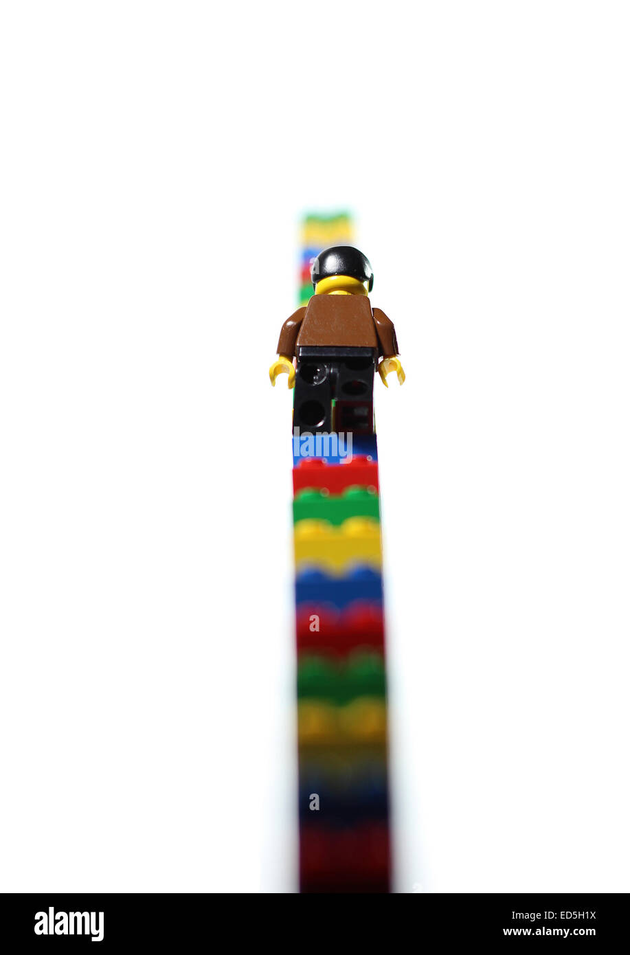 Lego figure climbing lego stairs. Rising. Stock Photo