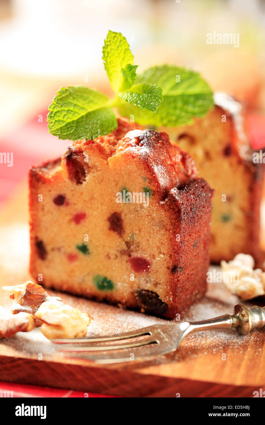 Two pieces of fruit cake on cutting board Stock Photo
