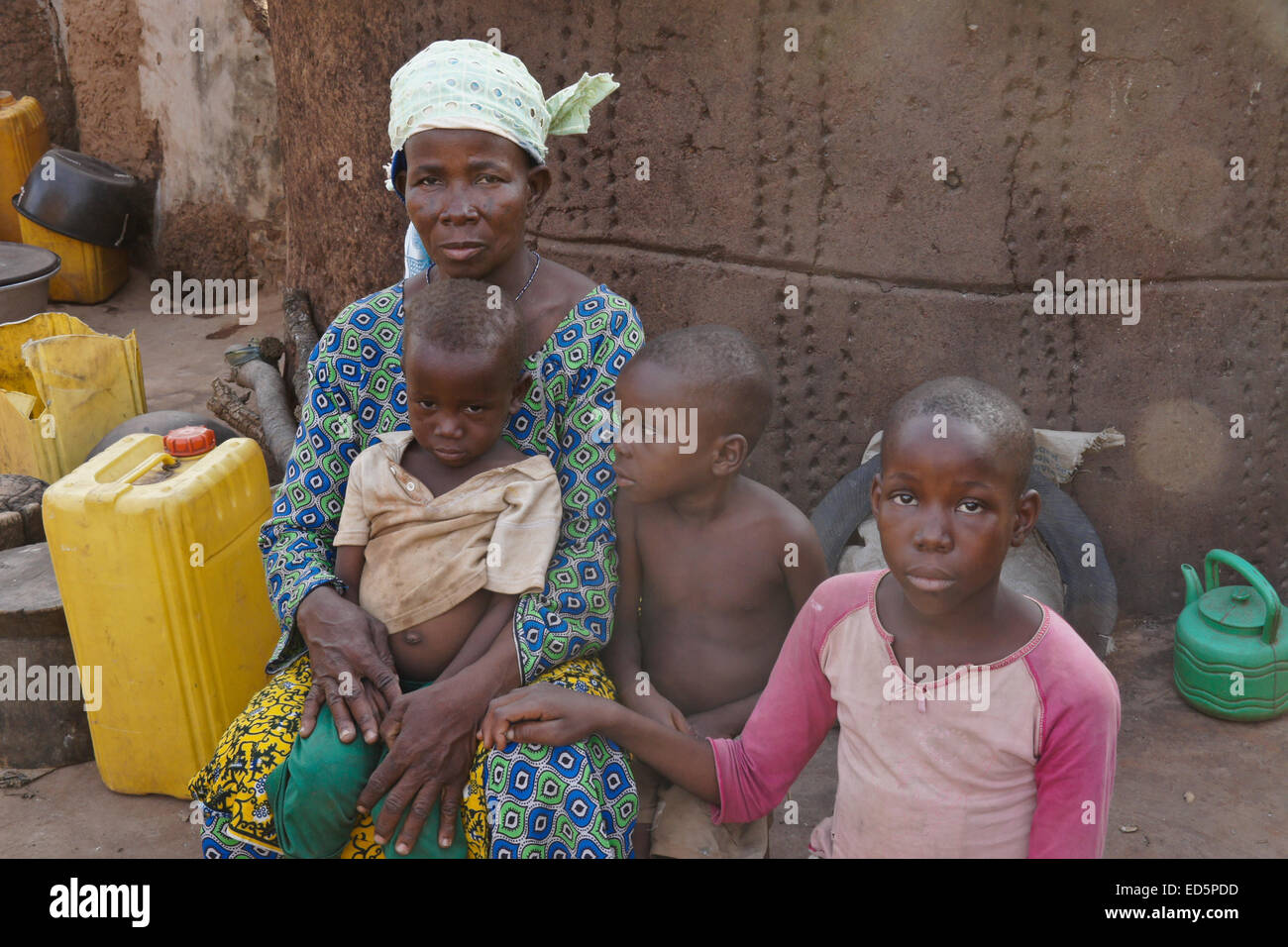 Woman and her children outside mud hut, Gambaga, Ghana Stock Photo
