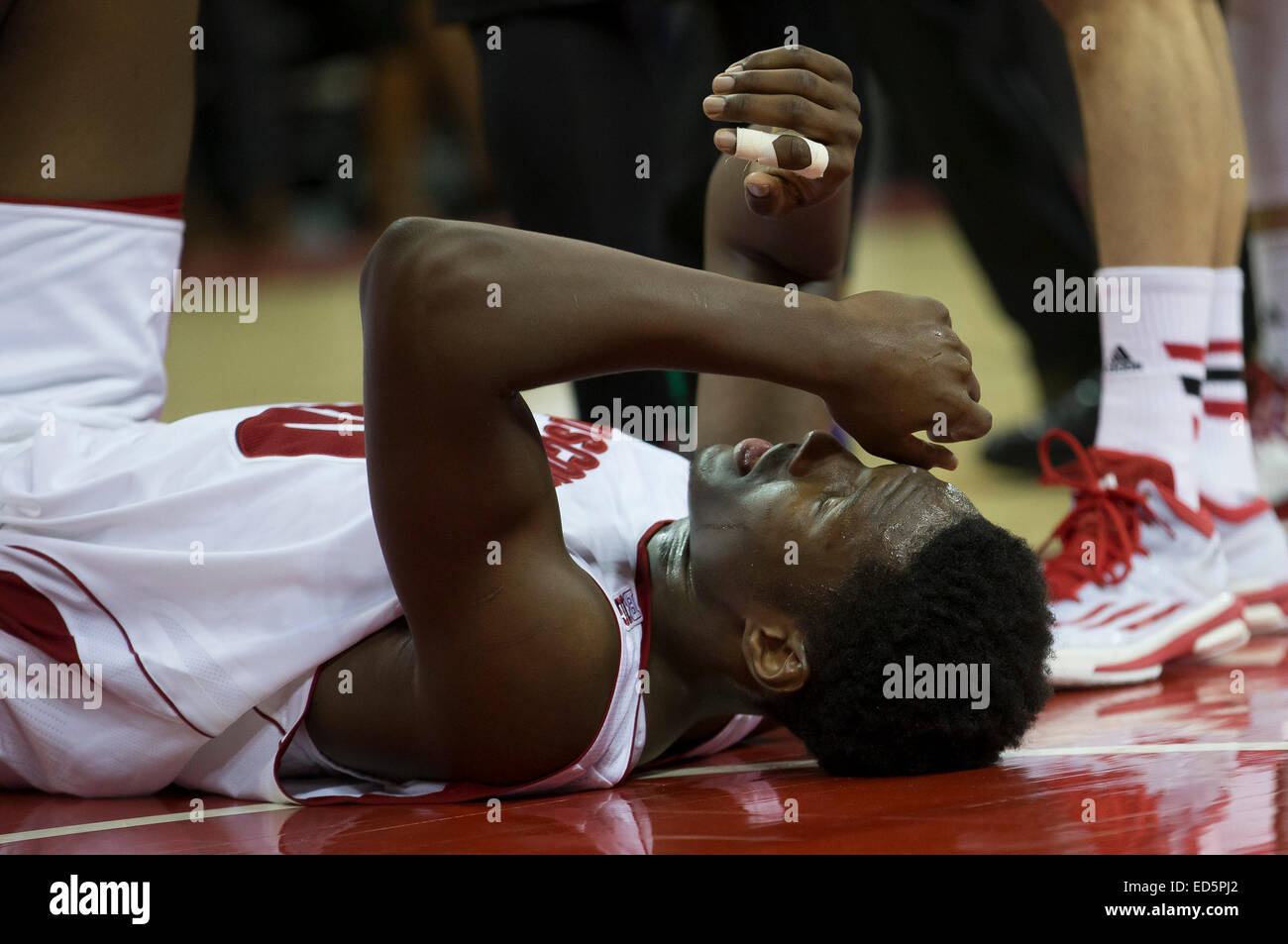 December 28, 2014: Wisconsin Badgers forward Nigel Hayes (10) falls to the floor after getting hit in the eye during the NCAA Basketball game between the Wisconsin Badgers and the Buffalo Bulls at the Kohl Center in Madison, WI. Wisconsin defeated Buffalo 68-56. John Fisher/CSM Stock Photo
