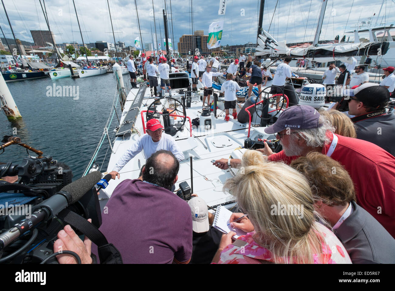 Hobart, Australia. 29th December, 2014. Hobart Australia,Sydney to Hobart Yacht Race. Super Maxi yacht Giacomo's captain meets the press at the docks in Hobart.The yacht arrived under engine power with a broken mast to join end of race celebrations. Credit:  mistadas/Alamy Live News Stock Photo