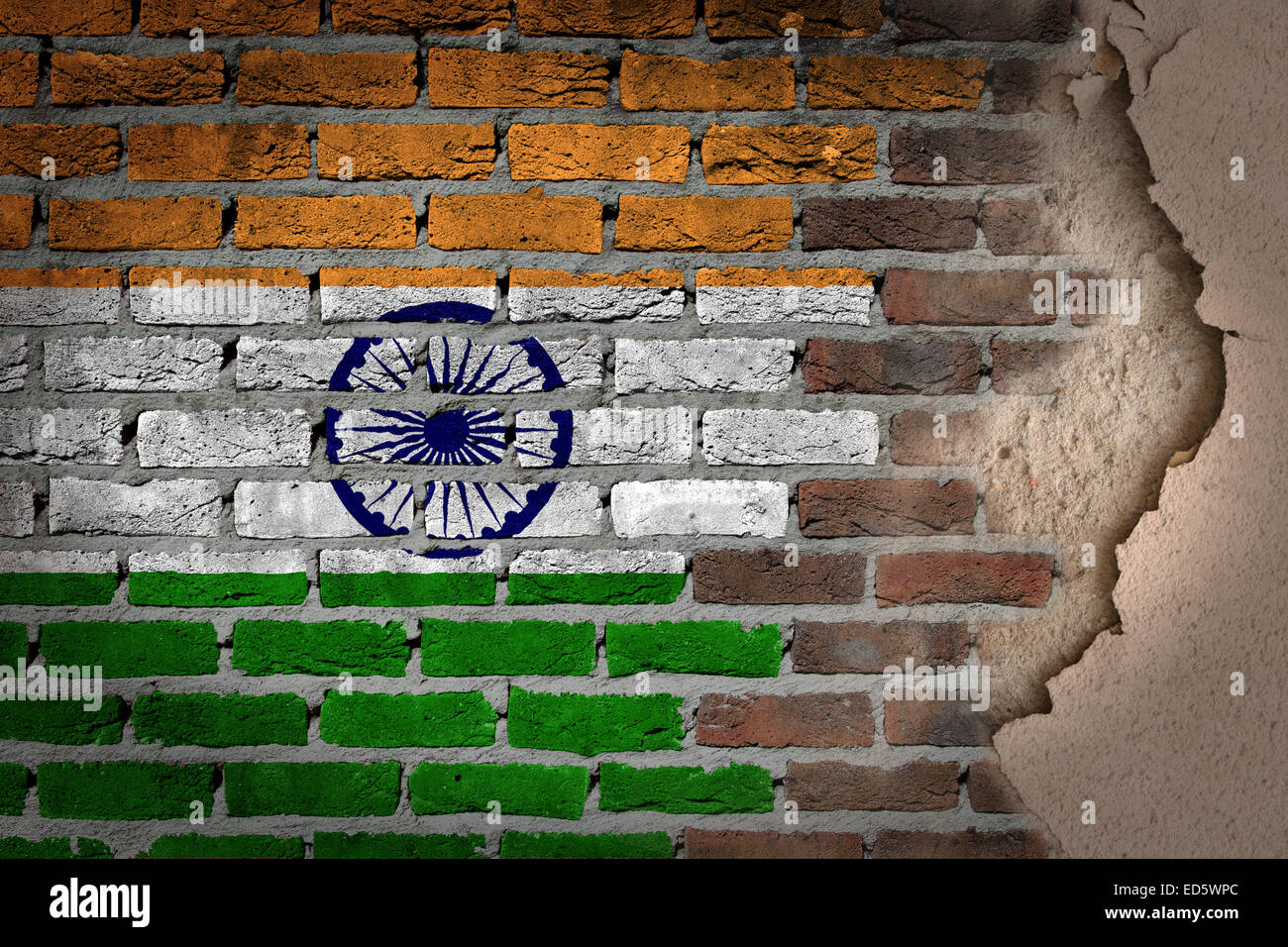 Dark brick wall texture with plaster - flag painted on wall - India Stock Photo
