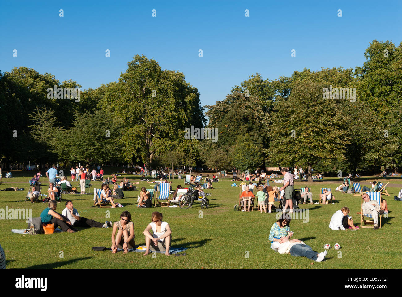 People relaxing on summer day in St James's Park, London, England, UK Stock Photo