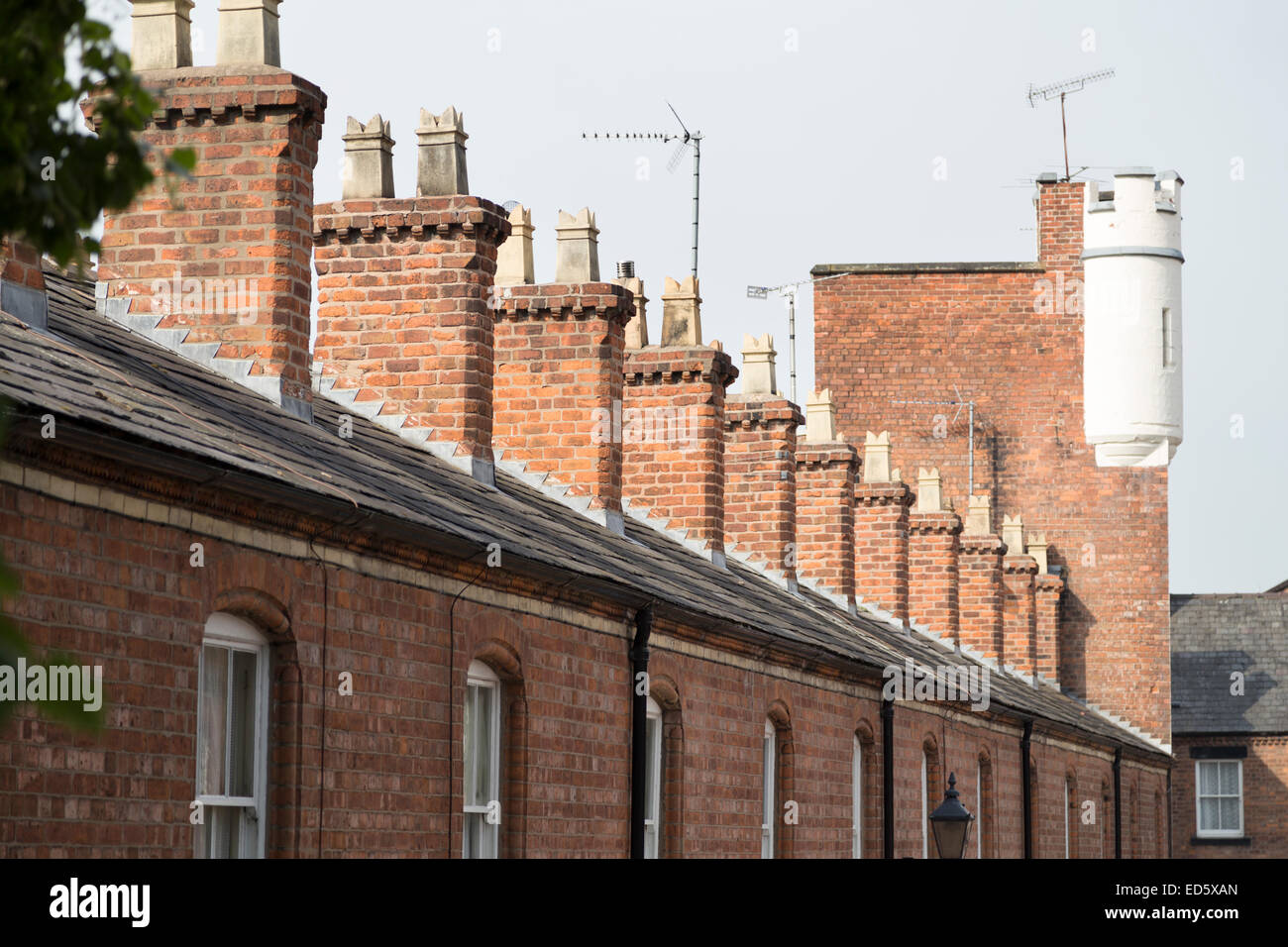 UK, Chester, a row of chimneys on houses with the last one looking like a castle turret. Stock Photo