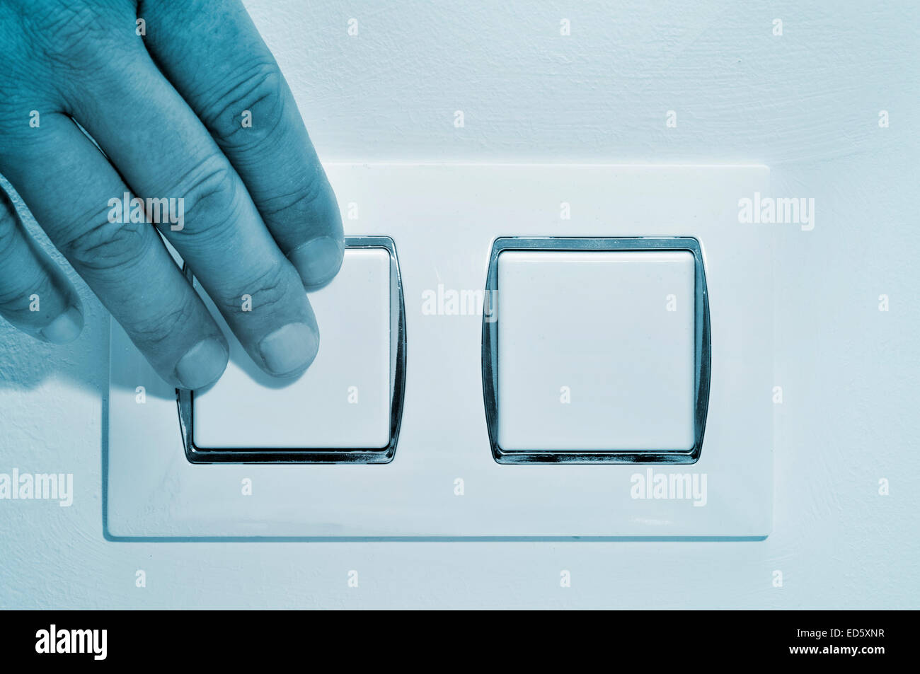a man pressing a wall switch Stock Photo - Alamy
