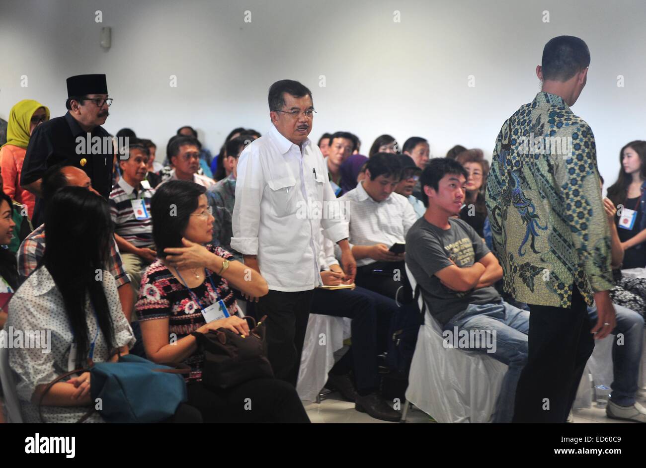 Jakarta, Indonesia. 29th Dec, 2014. Indonesian Vice President Jusuf Kalla (C) walks past family members of people on missing AirAsia flight QZ8501 at Juanda International Airport in Surabaya, Indonesia, Dec. 29, 2014. Air Asia Indonesia has released information about the 162 passengers and crew members on flight QZ8501, which lost contact with the air traffic control Sunday morning. Credit:  Zulkarnain/Xinhua/Alamy Live News Stock Photo