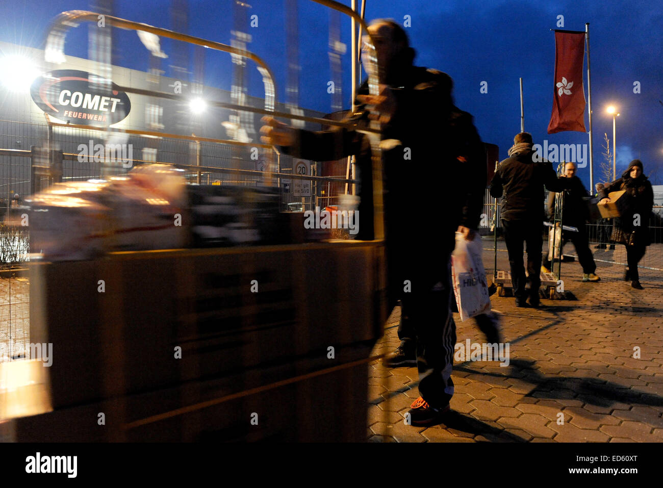 Bremerhaven, Germany. 29th Dec, 2014. Already at daybreak, customers carry boxes of fireworks at the factory sale of fireworks company Comet in Bremerhaven, Germany, 29 December 2014. PHOTO: INGO WAGNER/dpa/Alamy Live News Stock Photo