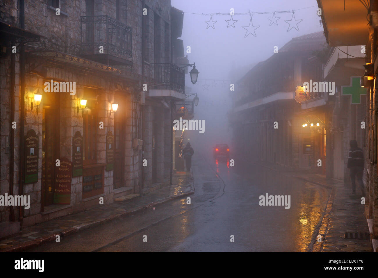 Night falling on misty Arachova, the most popular winter resort in Greece, Mount Parnassos, Viotia., Central Greece. Stock Photo