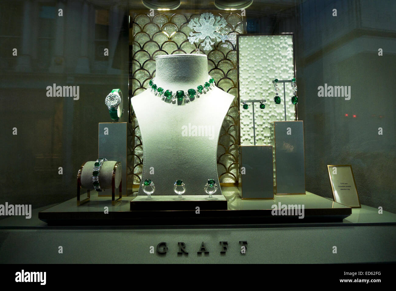 Emerald jewellery in the shop window of Graff jewelers at Christmas time in Old Bond Street, London UK  KATHY DEWITT Stock Photo