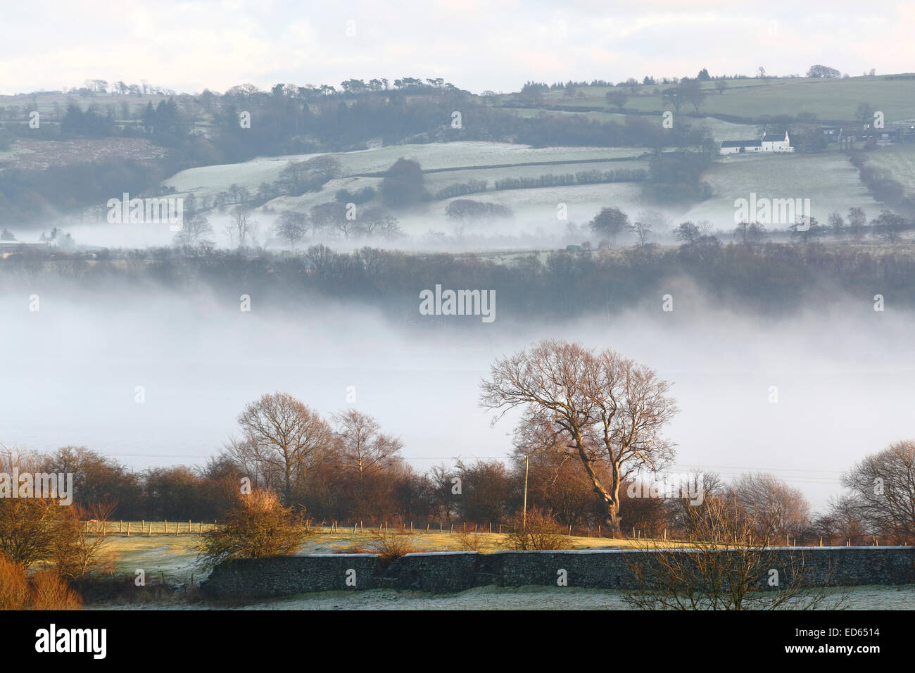 Lochwinnoch, Renfrewshire, Scotland, UK. 29th December, 2014. UK Weather:  Following overnight frost, freezing fog persisted for most of the day before the sun finally broke through mid afternoon with a temperature inversion over Castle Semple Loch Stock Photo