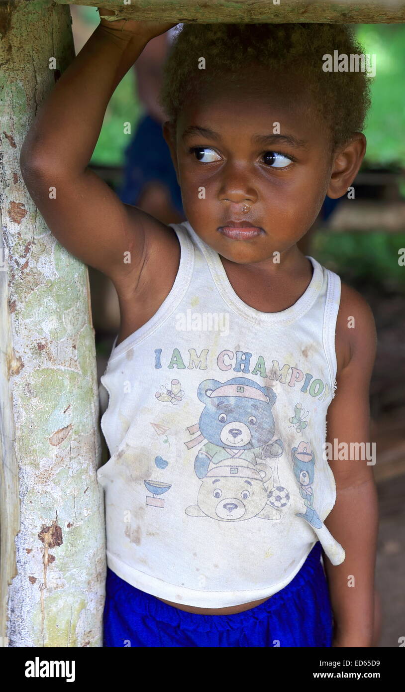 PENTECOSTES,VANUATU-OCTOBER 15, 2014: Little boy accompanies her mother who sells fruit at a stall near the airport on October 1 Stock Photo