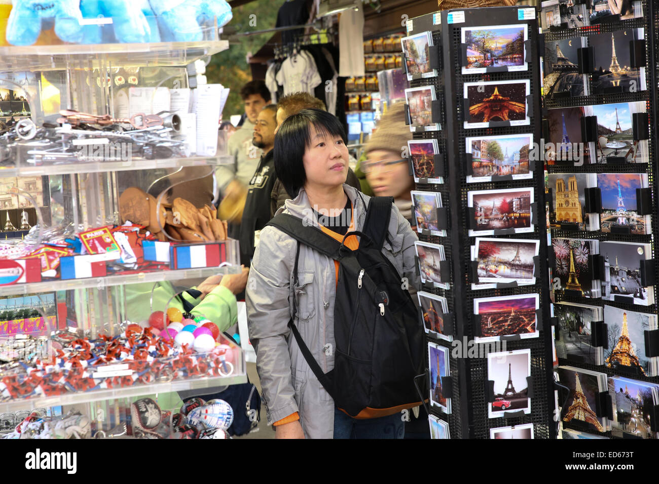 Chinese tourist Asian female looking postcard Paris Stock Photo
