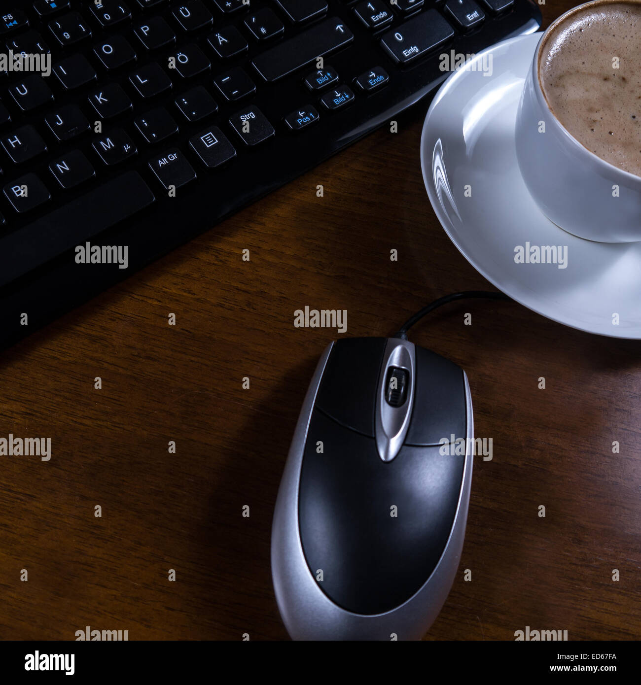 keyboard, cup coffee and mouse on desk Stock Photo