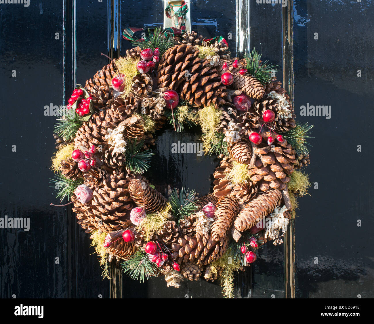 Christmas wreath of fir cones and berries on a house door Durham City north east England, UK Stock Photo