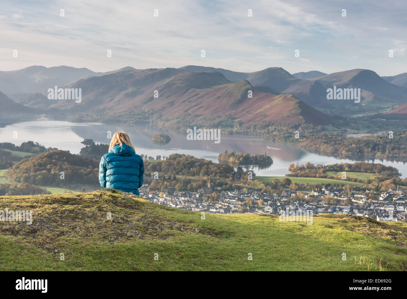 Hiker enjoying the view from Latrigg over Keswick and Derwent Water to Cat Bells in the English Lake District Stock Photo