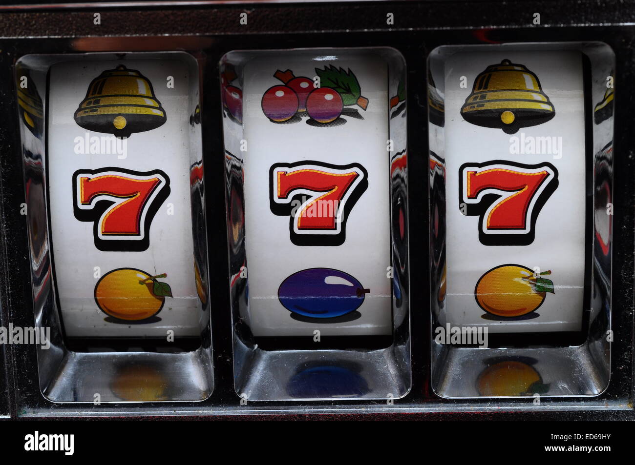 Close up of three seven jackpot on a casino slot machine Stock Photo