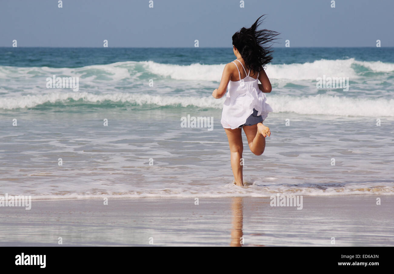 Beautiful young woman at the beach Stock Photo