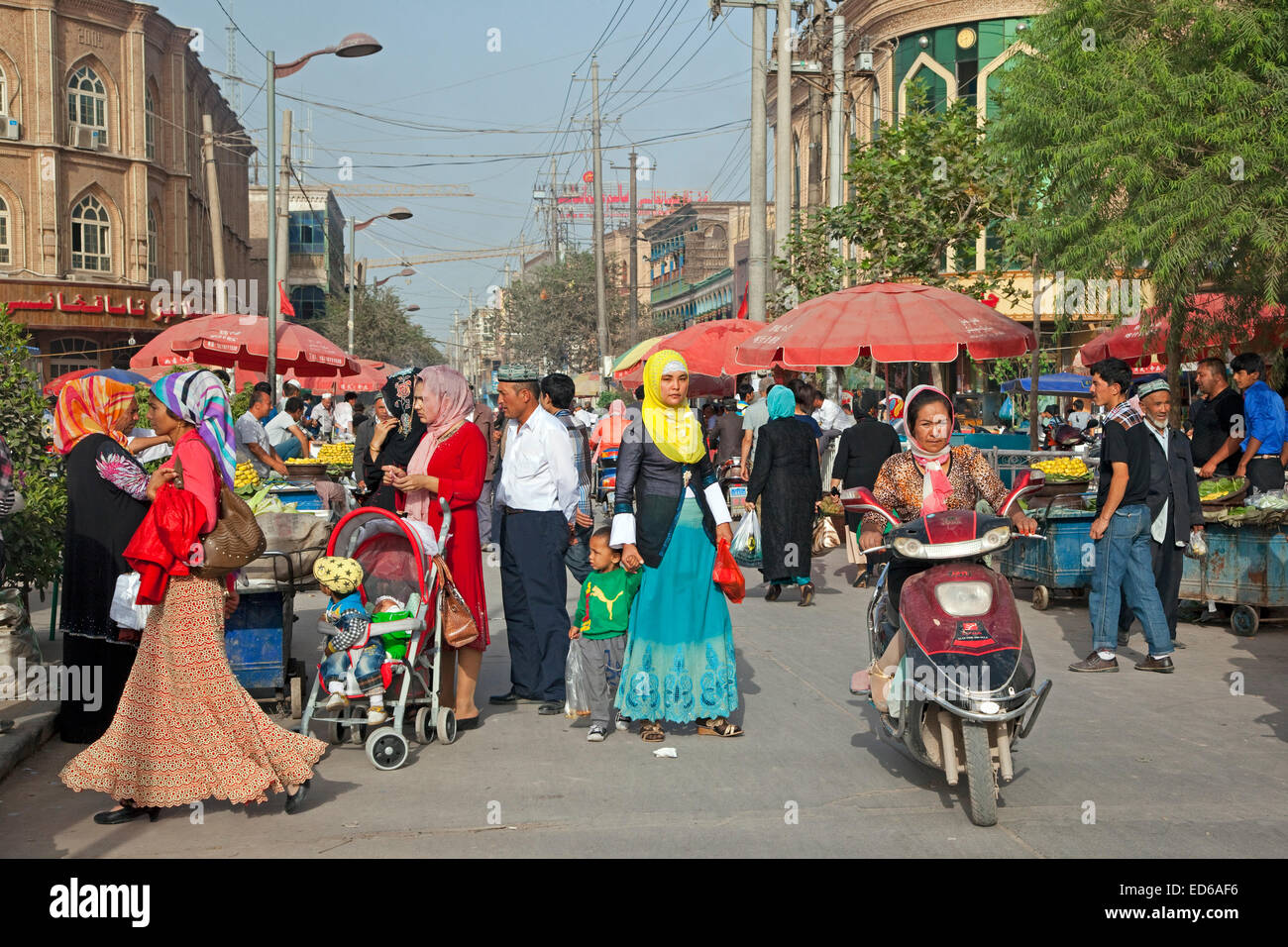 Uyghur Muslim women wearing Islamic dress in shopping street in the city Kashgar / Kashi, Xinjiang Province, China Stock Photo