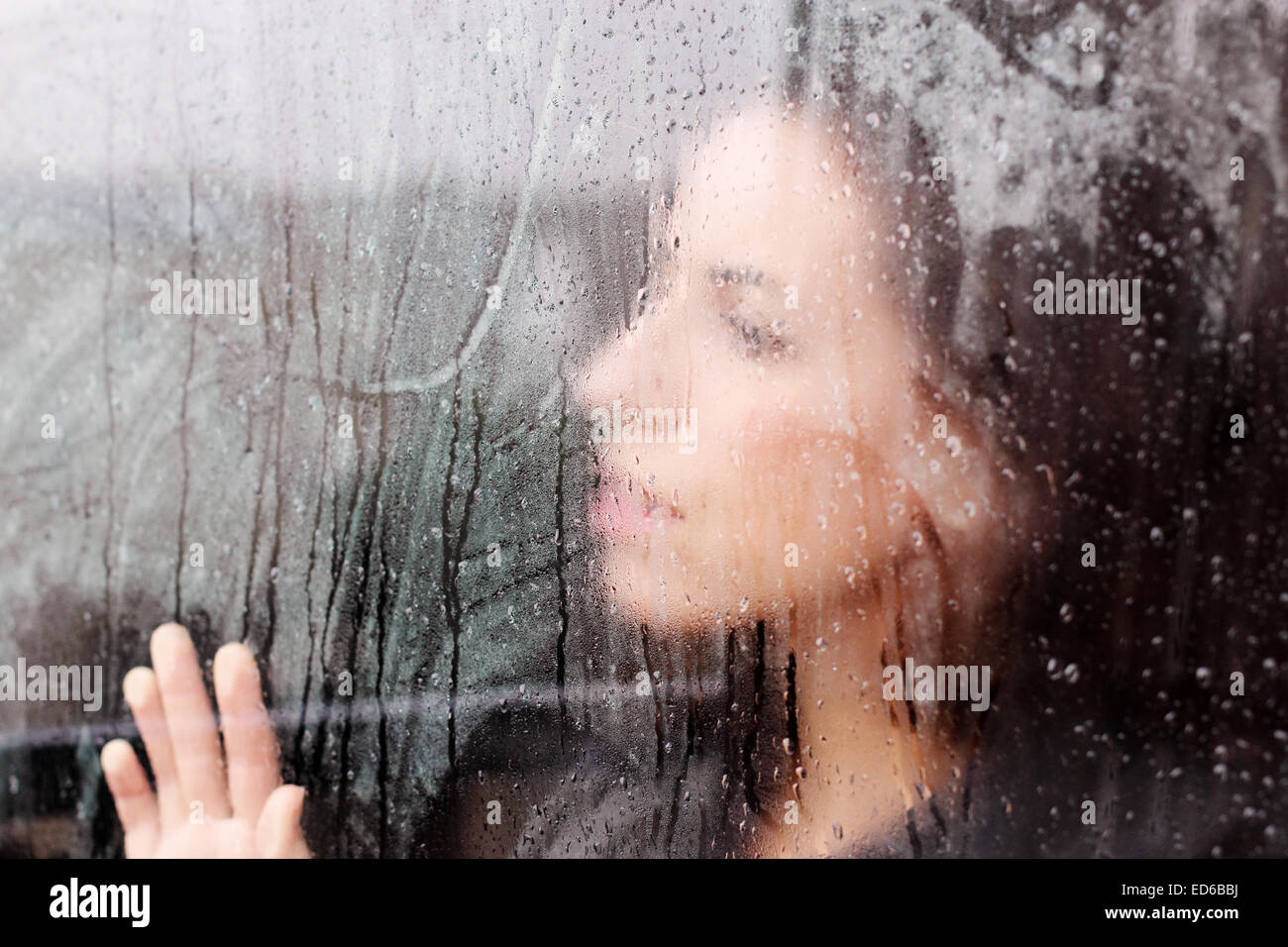 beautiful 35 year old woman stands in front of the window Stock Photo