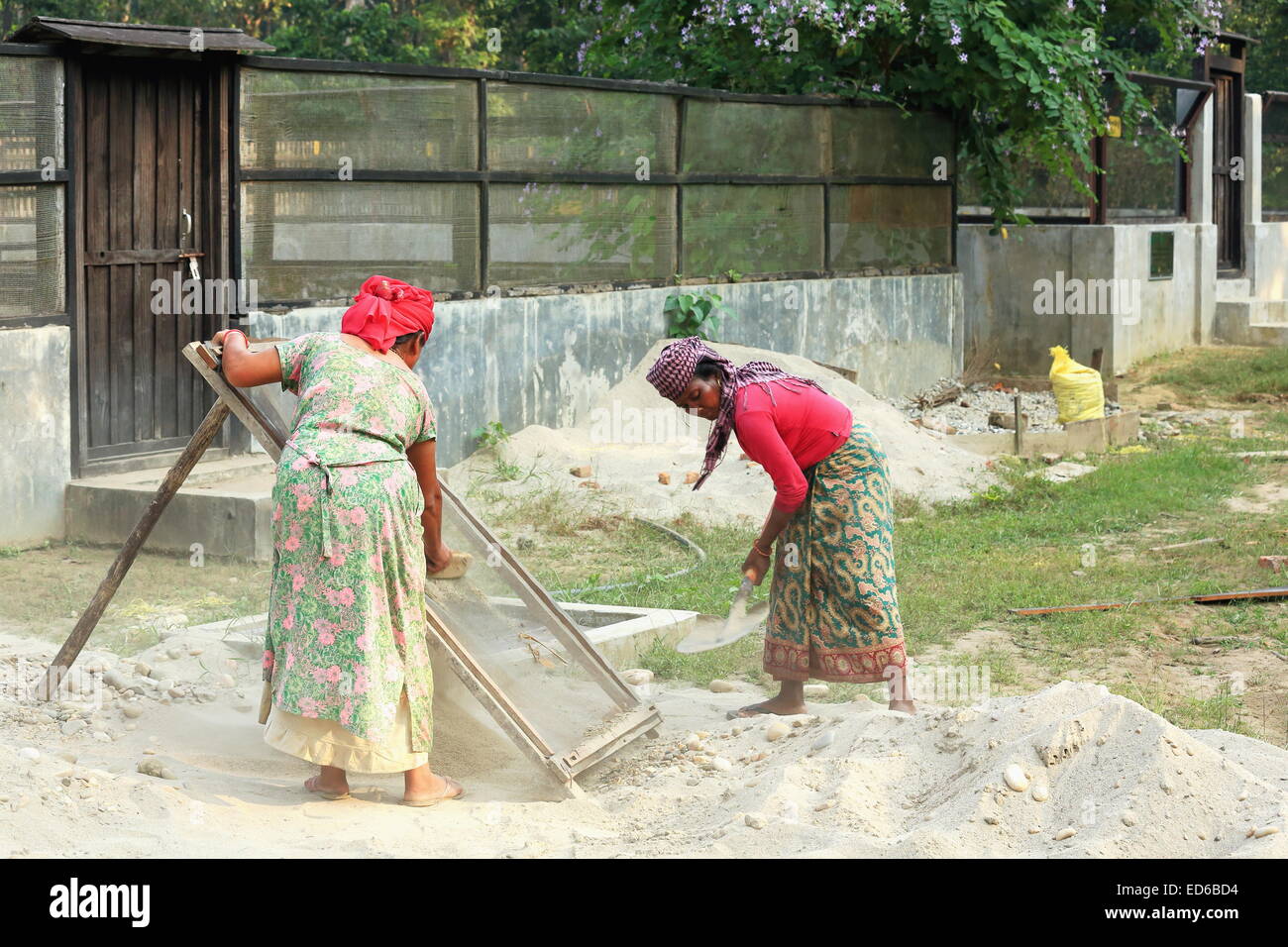 CHITWAN, NEPAL - OCTOBER 14: Local women work in maintenance tasks of the Gharial Conservation Program facilities on October 14, Stock Photo