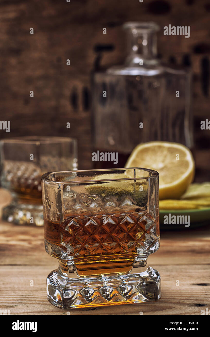 seasoned brandy into the glasses and decanter vintage style Stock Photo Alamy