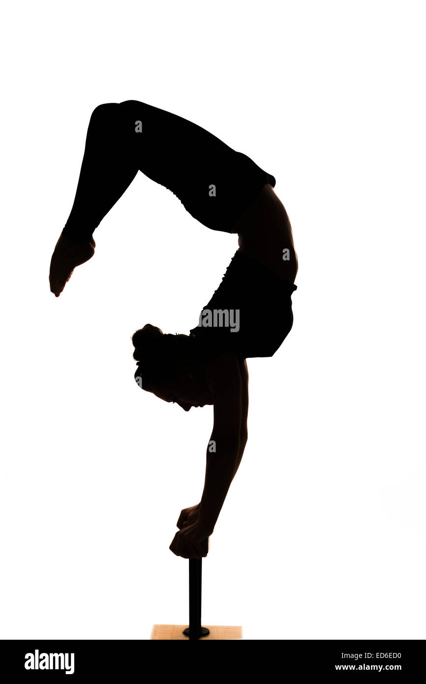 one caucasian woman contortionist practicing gymnastic yoga in silhouette on white background Stock Photo