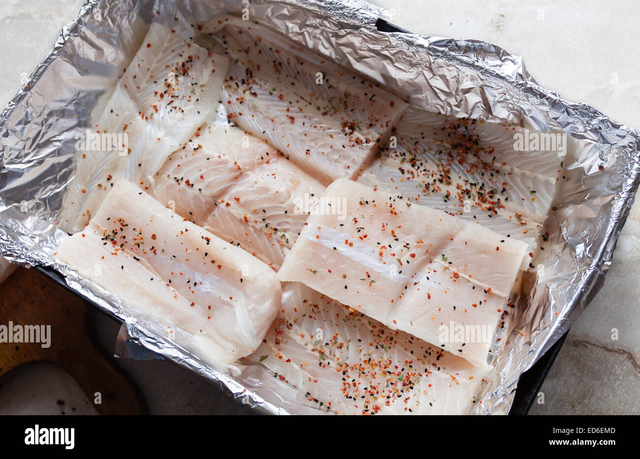 https://c8.alamy.com/comp/ED6EMD/atlantic-cod-fresh-raw-fish-fillet-with-herbs-on-foil-aluminum-ready-ED6EMD.jpg