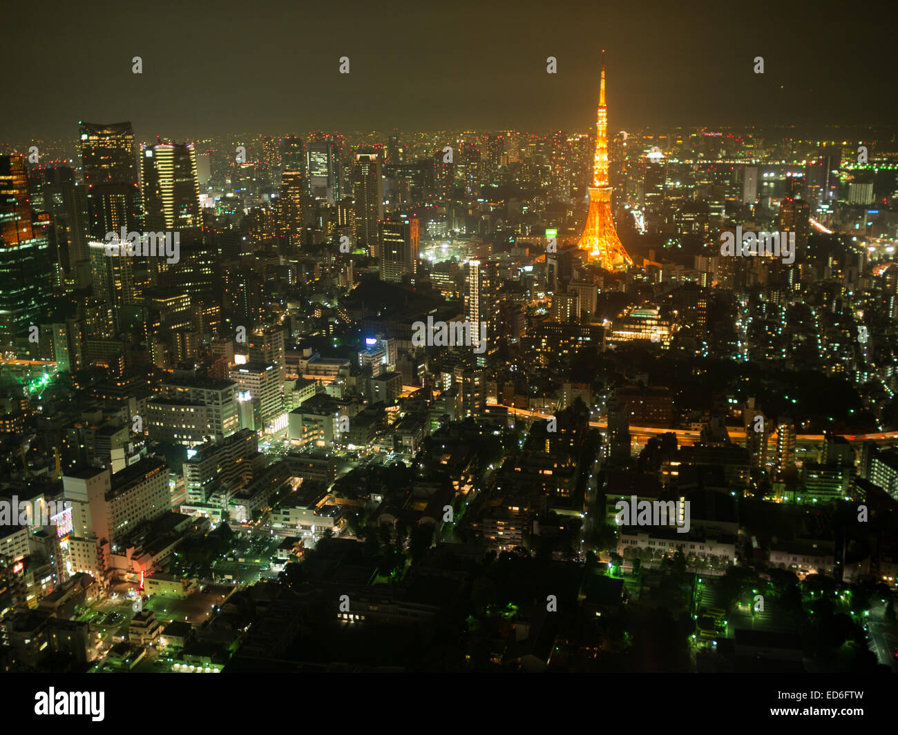 Tokyo Tower between the city landscape in the night lights Stock Photo
