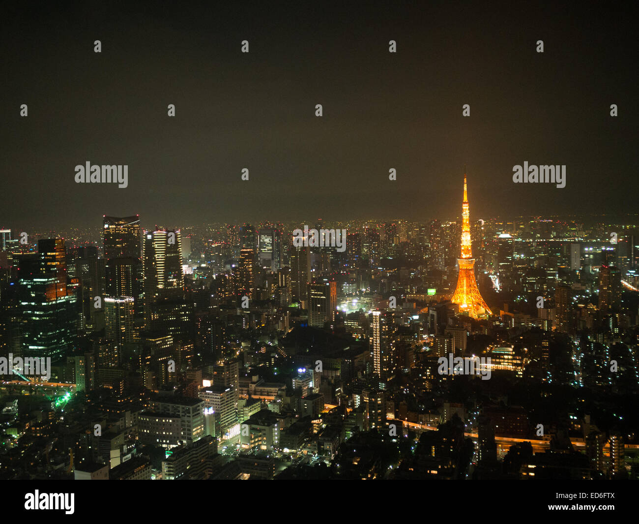 Tokyo Tower between the city landscape in the night lights Stock Photo