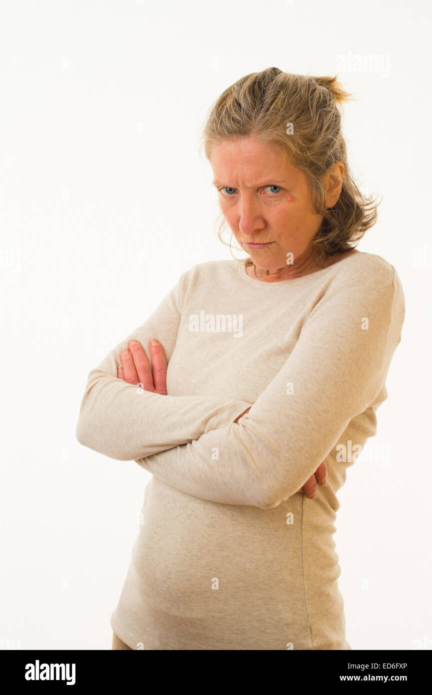 A moody sulky angry forty year old caucasian woman with her arms folded