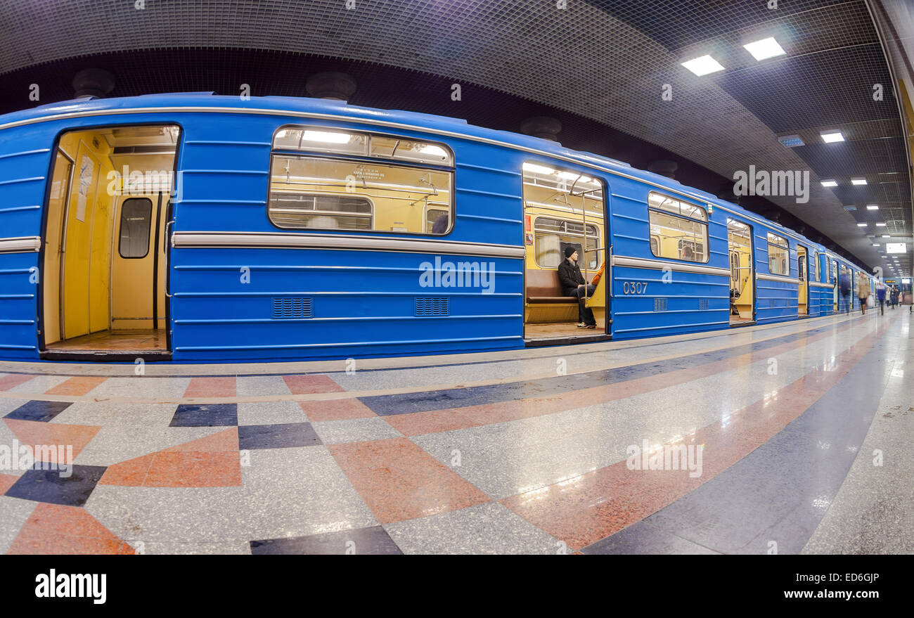 Blue subway train standing at the underground station. Wide angle Stock Photo