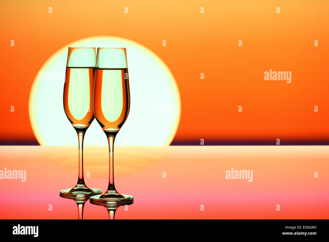 https://c8.alamy.com/comp/ED6GR0/two-champagne-glasses-at-sunset-close-up-ED6GR0.jpg
