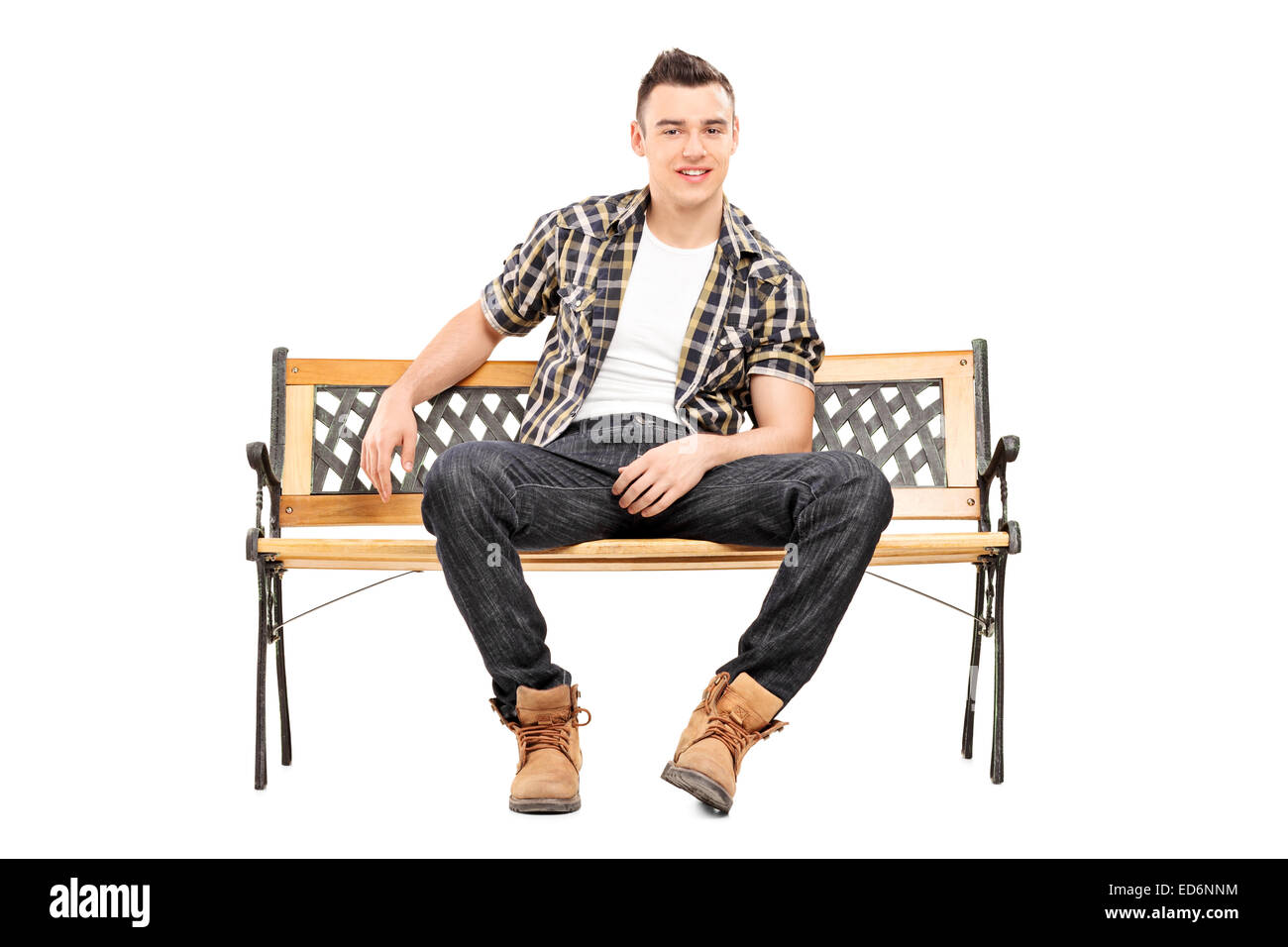 Cool young male model sitting on a bench isolated on white background Stock Photo