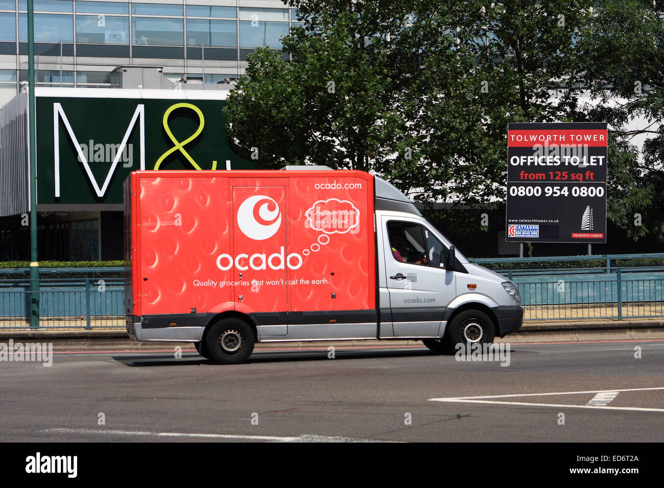 An Ocado truck passing a Marks and Spencer sign at Tolworth, Surrey, England. Stock Photo