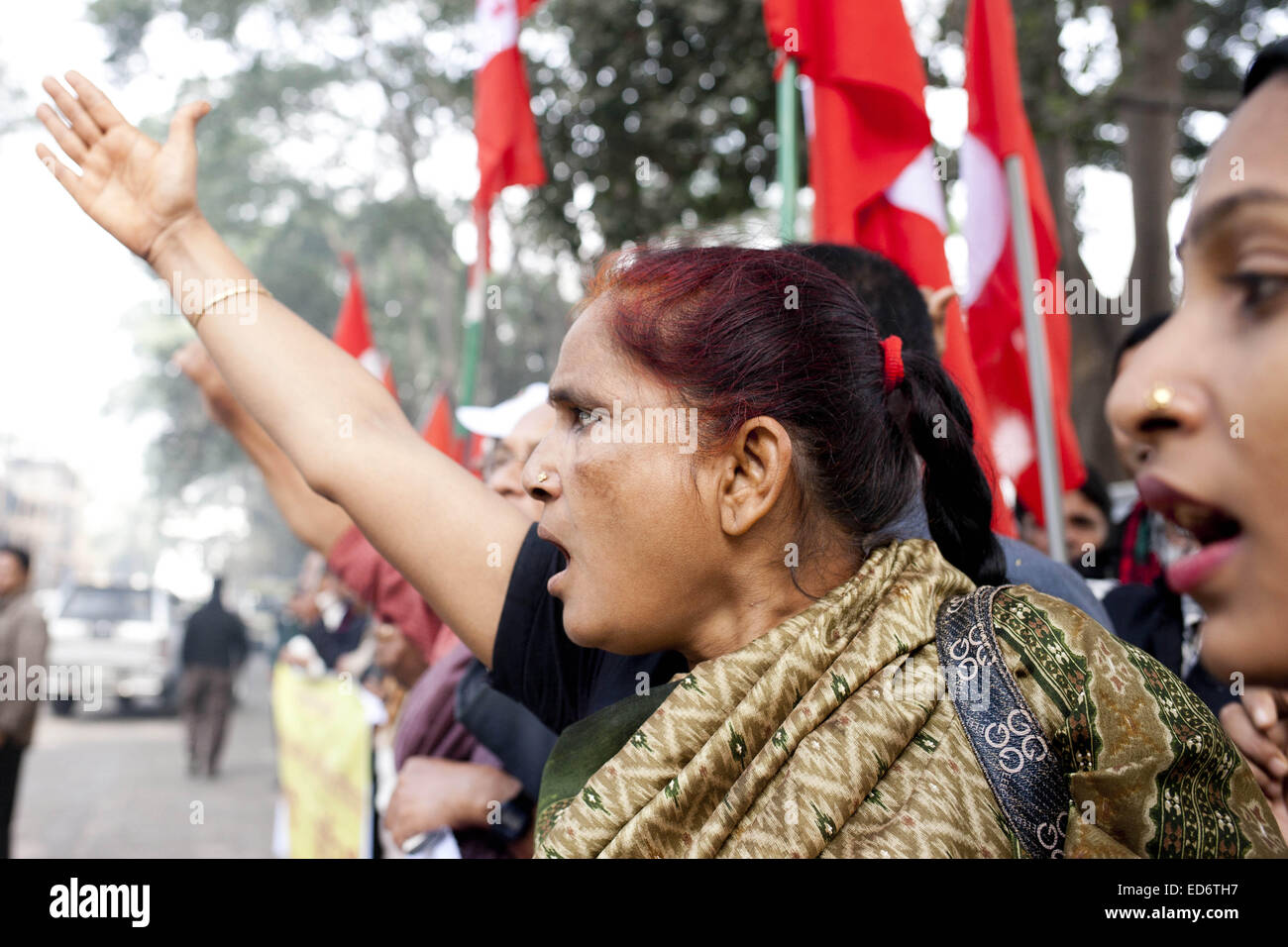 Dhaka, Bangladesh. 30th Dec, 2014. Bangladeshi activists shout slogans against war criminals as they wait outside a special war crimes tribunal ahead of a verdict for Al-Badr commander ATM Azharul Islam in Dhaka, Bangladesh, Tuesday, Dec. 30, 2014. The special tribunal in Bangladesh on Tuesday sentenced the former Cabinet member to death after convicting him of collaborating with the Pakistani army to help carry out several killings of civilians during Bangladesh's 1971 independence war. Credit:  Suvra Kanti Das/ZUMA Wire/ZUMAPRESS.com/Alamy Live News Stock Photo