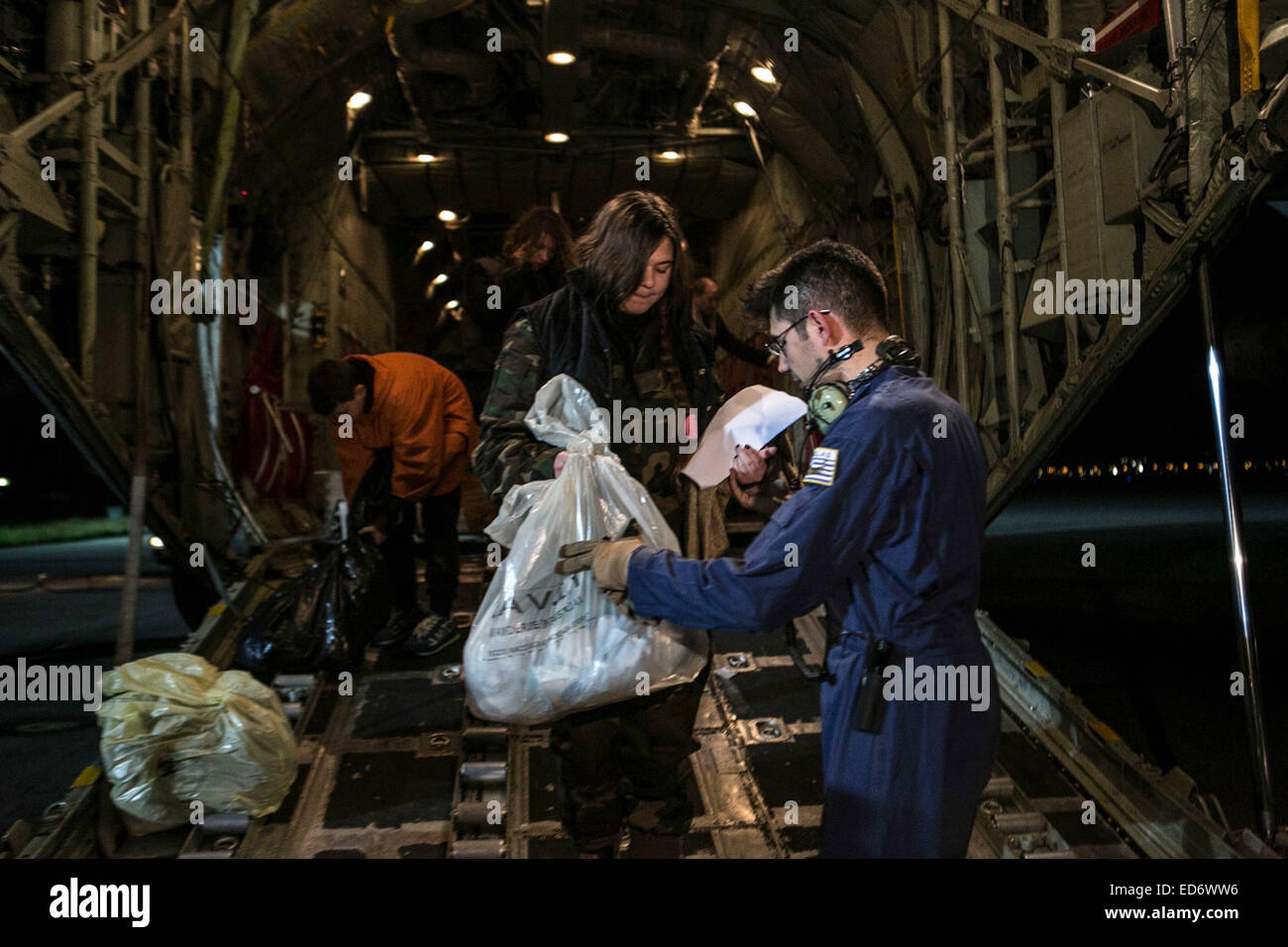 Athens, GREECE. 30th Dec, 2014. Rescued passengers of the ''Norman Atlantic'' accident arrive from Italy at Elefsina Air Base outside Athens. About 43 passengers from the Norman Atlantic arrived in the greek capital as the death toll climbed to 10 as survivors told of a frantic rush to escape, caught among flames, pelting rain and passengers who fought others for rescue. © Aristidis Vafeiadakis/ZUMA Wire/Alamy Live News Stock Photo