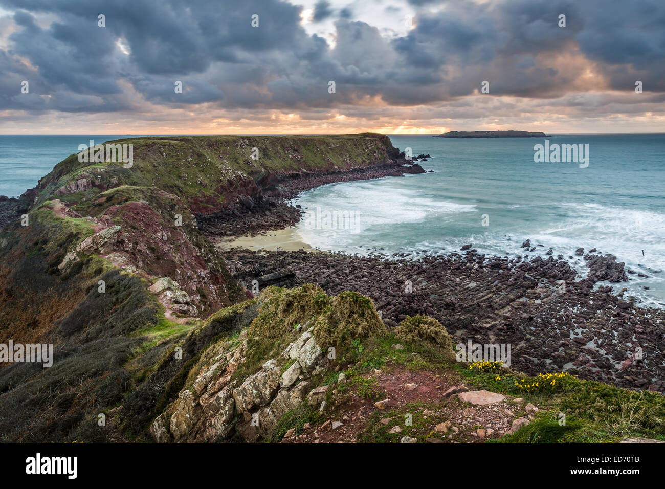 Albion Sands near Marloes beach in Pembrokeshire. Looking out towards Skokholm Island at sunset on a winters day Stock Photo