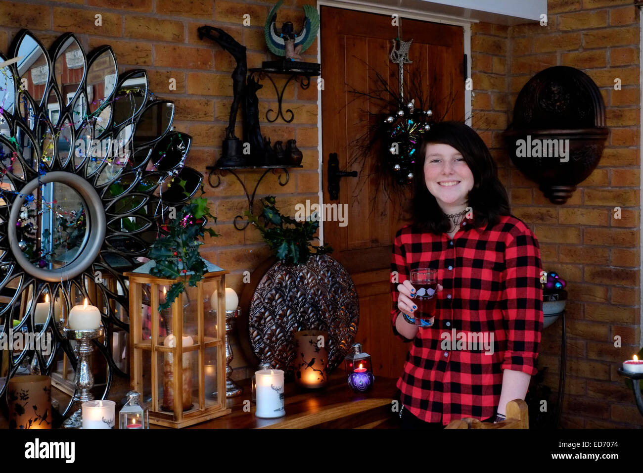 twelve year old girl with soft drink waiting for christmas dinner to be