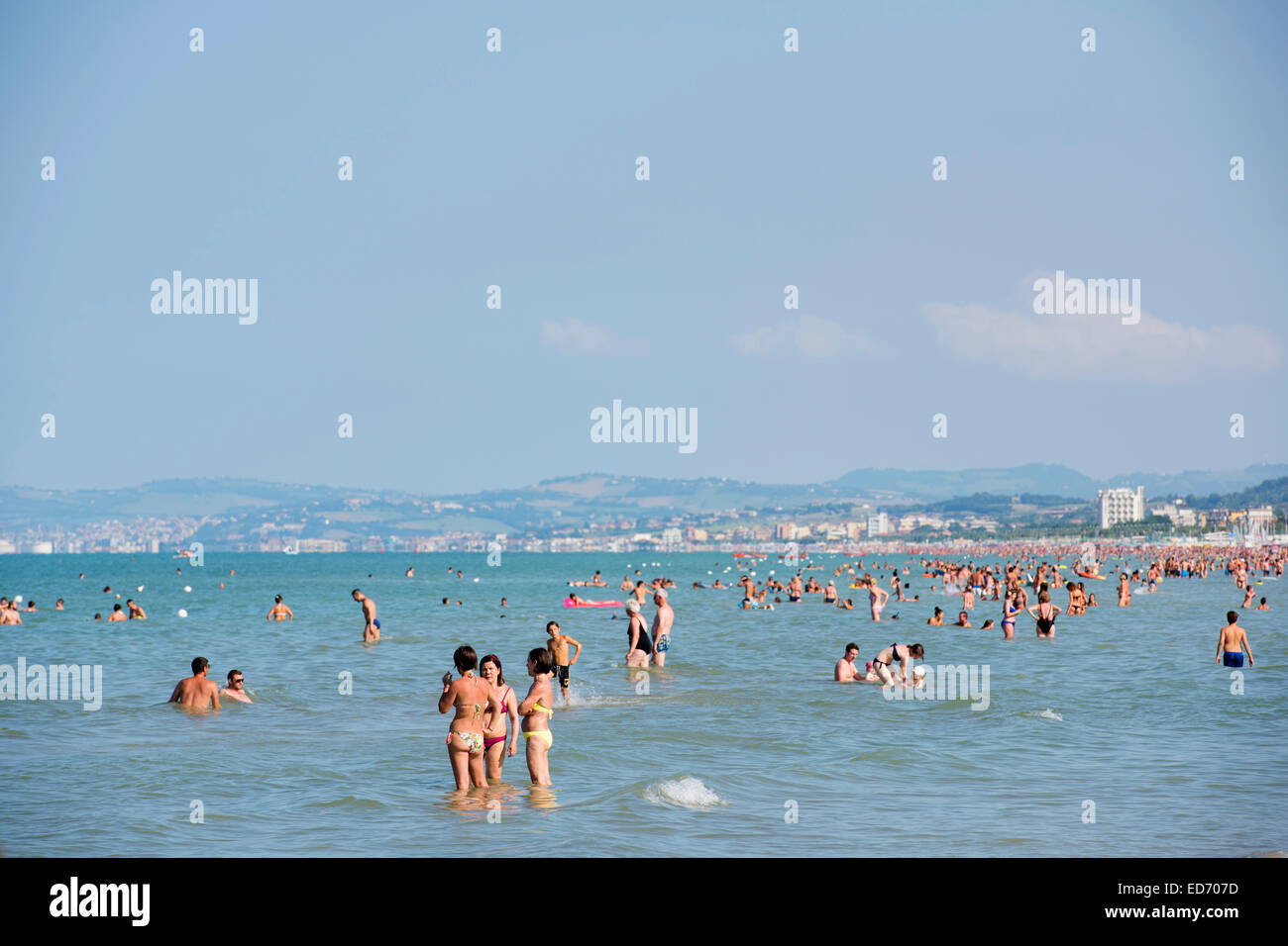 Tourists bathing in the sea, town of Ancona at the back, Senigallia, Province of Ancona, Marche, Italy Stock Photo